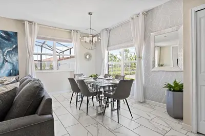 a living room with a dining room table and chairs at Casa 5Q c/ Piscina Privativa - Storey Lake Resort in Kissimmee