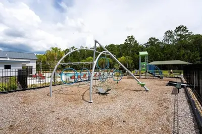 an empty playground with a swing set in a park at Casa 5Q c/ Piscina Privativa - Storey Lake Resort in Kissimmee