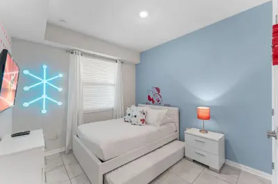 a bedroom with a bed with a snowflake painted on the wall at 3121-207 Resort Lake View Disney Universal Orlando in Kissimmee