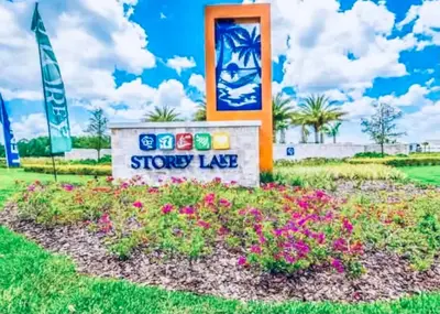 a sign for a showy lake with flowers at 3121-207 Resort Lake View Disney Universal Orlando in Kissimmee