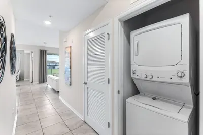 a laundry room with a washer and dryer at 3121-207 Resort Lake View Disney Universal Orlando in Kissimmee