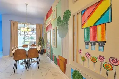 a dining room with a table and a painting on the wall at Let's Glo Now Adventure Cove Villa townhouse in Kissimmee
