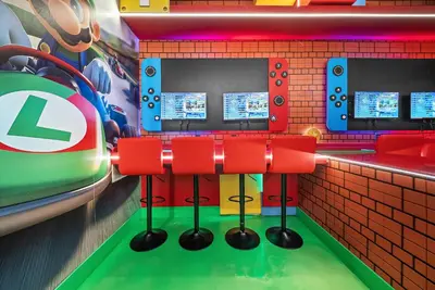 a bar with red bar stools in a lego restaurant at Brand NEW 5 BRD At Paradiso Grande Near Sea World in Orlando