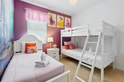 a bedroom with two bunk beds and a ladder at Lake Side View Private Pool Home In Resort! villa in Kissimmee