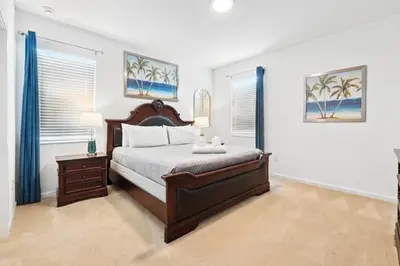 a bedroom with a large bed and two windows at Lake Side View Private Pool Home In Resort! villa in Kissimmee
