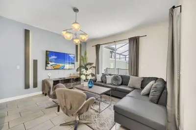 a living room with a couch and a table at Retreat & Relax Screened In Pool Home Kid Rooms townhouse in Kissimmee
