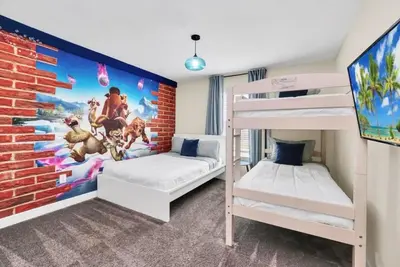 a bedroom with two bunk beds and a brick wall at Retreat & Relax Screened In Pool Home Kid Rooms townhouse in Kissimmee