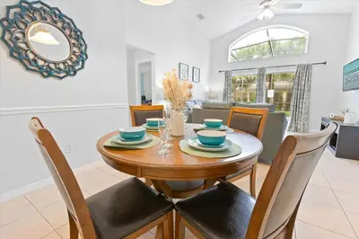 a dining room with a wooden table and chairs at Casa 5Q c/ Piscina Priv. e Sala de Jogos in Kissimmee