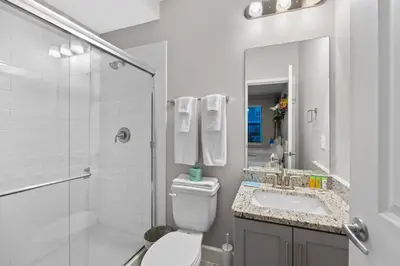 a bathroom with a toilet and a sink and a shower at Gated community 4BD townhouse next to Disney in Kissimmee