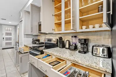 a kitchen with white cabinets and a counter top at Gated community 4BD townhouse next to Disney in Kissimmee