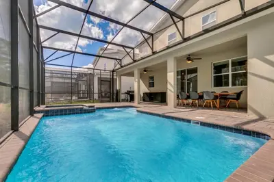 a swimming pool in a house with a glass ceiling at 6 Bedrooms 6 Bathrooms Storey Lake home in Orlando