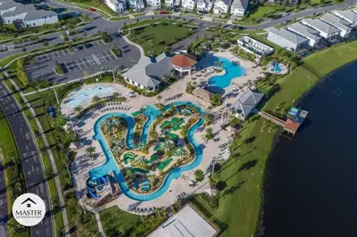 an aerial view of a pool at a resort at 9 Bedrooms 5 Bathrooms Storey Lake home in Kissimmee