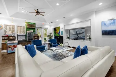 a living room with a white couch and blue chairs at 3 Bedrooms 2 Bathrooms Lucaya Village townhouse in Kissimmee