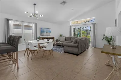 a living room with a table and chairs and a couch at 3 Bedrooms 2 Bathrooms Lake Berkley home in Kissimmee