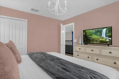 a bedroom with a bed and a flat screen tv at 8 Bedroom & Theme Rooms For Kids In Storey Lake home in Kissimmee