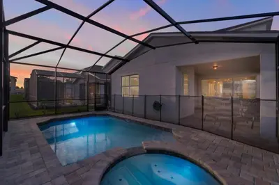 a swimming pool in a house with a roof at 5 Bedrooms 5,5 Bathrooms Solara home in Orlando