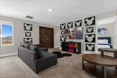 a living room with a couch and a table at 9 Bed Storey Lake Star Wars Dream Home home in Kissimmee