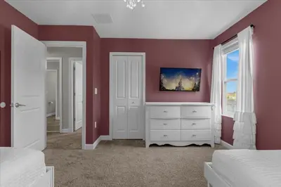 a bedroom with red walls and a white dresser at 9 Bed Storey Lake Star Wars Dream Home home in Kissimmee
