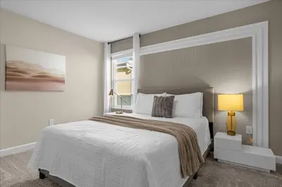 a bedroom with a large bed and a window at 9 bed Home Storey Lake home in Kissimmee