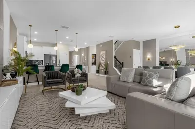 a living room with a couch and a table at 9 bed Home Storey Lake home in Kissimmee