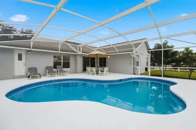a pergola over a swimming pool in a house at Ultimate Resort Gateway in Orlando