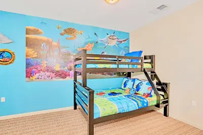 a bedroom with a bunk bed with a fish themed wall at Modern 3BR Condo w Private Patio 7min to Disney in Orlando