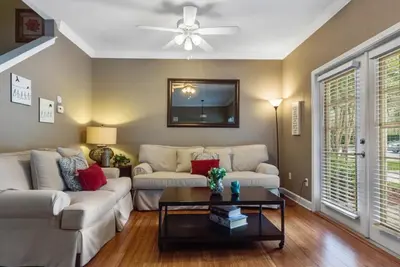 a living room with a couch and a table at 4 Bedrooms 3 Bathrooms Lucaya Village townhouse in Kissimmee