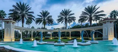 a pool with water fountains and palm trees at Southern Comfort Private Pool Spa Near Disney! villa in Kissimmee