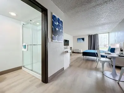 a room with a glass door leading to a bedroom at Stayable Kissimmee East in Kissimmee