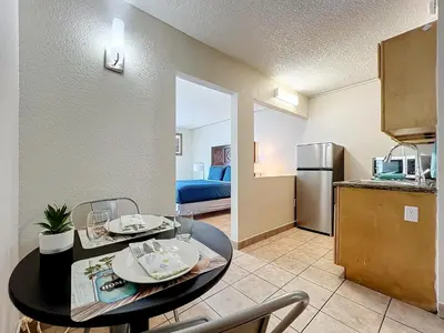 a kitchen and dining room with a table in a room at Stayable Kissimmee East in Kissimmee