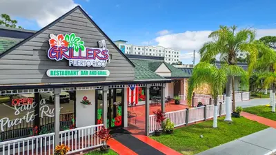 a restaurant with a sign on the front of it at Stayable Kissimmee East in Kissimmee