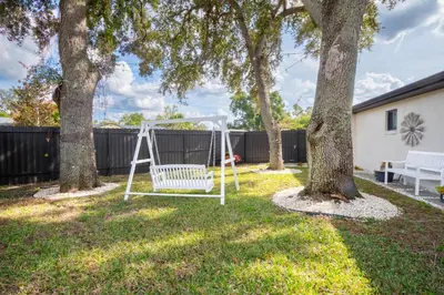 a swing in a yard with trees at Longwood Private Suite - Near Orlando - Modern, Private Entrance, Fast WiFi in Orlando