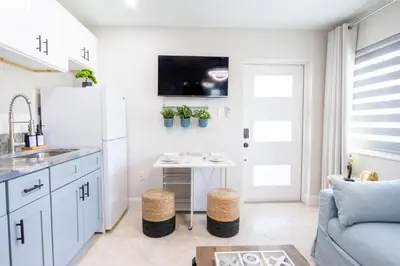 a kitchen with a white refrigerator and a table at Longwood Private Suite - Near Orlando - Modern, Private Entrance, Fast WiFi in Orlando