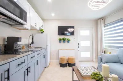 a kitchen and living room with a white refrigerator at Longwood Private Suite - Near Orlando - Modern, Private Entrance, Fast WiFi in Orlando