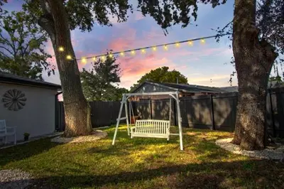 a swing in a yard between two trees at Longwood Private Suite - Near Orlando - Modern, Private Entrance, Fast WiFi in Orlando