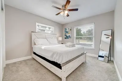a bedroom with a bed and a ceiling fan at Spacious Casselberry House with Backyard Pool in Orlando
