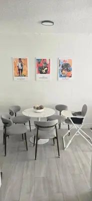 a room with tables and chairs and posters on the wall at Close to the Action, Peaceful When You Return in Orlando