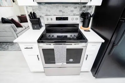 a kitchen with a stove and a refrigerator at Close to the Action, Peaceful When You Return in Orlando