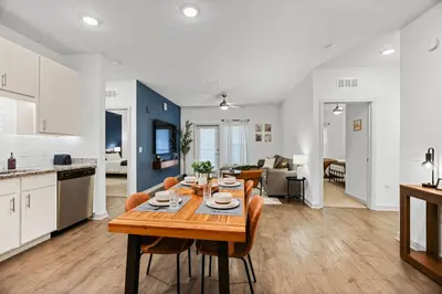 a kitchen and living room with a table and chairs at Magical Retreat Outside of Disney in Orlando