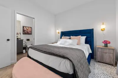 a bedroom with a large bed with a blue headboard at Bright Modern Townhome Retreat in Kissimmee
