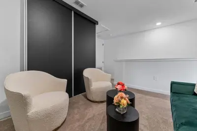 a room with two chairs and a table with flowers on it at Bright Modern Townhome Retreat in Kissimmee