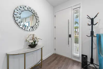 a mirror on a wall in a room with a table at Bright Modern Townhome Retreat in Kissimmee