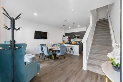 a kitchen and dining room with a table and a staircase at Bright Modern Townhome Retreat in Kissimmee