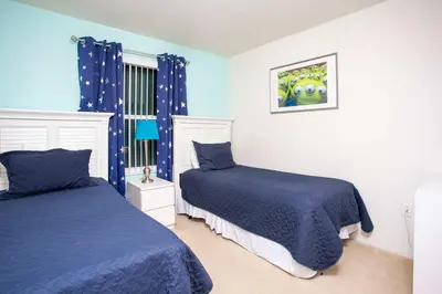 a bedroom with two beds and blue walls at Family Friendly 4 Bedrooms with GameRoom close to Disney in Compass Bay 5103 in Kissimmee