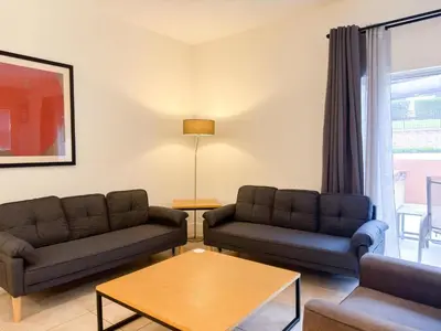 a living room with two couches and a table at ER3047WOR - Cozy 3BD Townhome w/ Private Hot Tub in Kissimmee