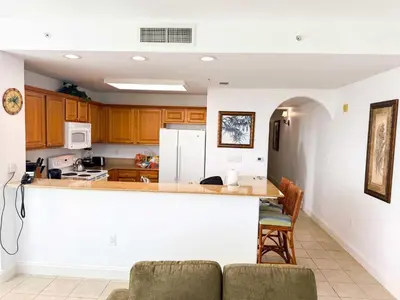a kitchen with wooden cabinets and a white counter top at BHBR207 - Condo Close to Disney - 1 mile in Orlando