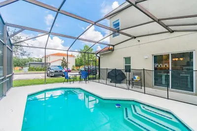 a swimming pool in front of a house at Modern Pool Townhome Minutes to Disney in Kissimmee