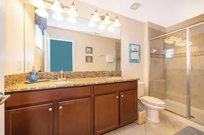 a bathroom with a toilet and a sink and a shower at Florida Dreaming home in Kissimmee