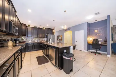 a large kitchen with a island in the middle at Florida Dreaming home in Kissimmee