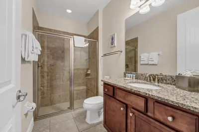 a bathroom with a shower and a toilet and a sink at Home With Private Pool, Theme & Game Room Near Disney With Resort & Waterpark Access - 7521Mr in Orlando